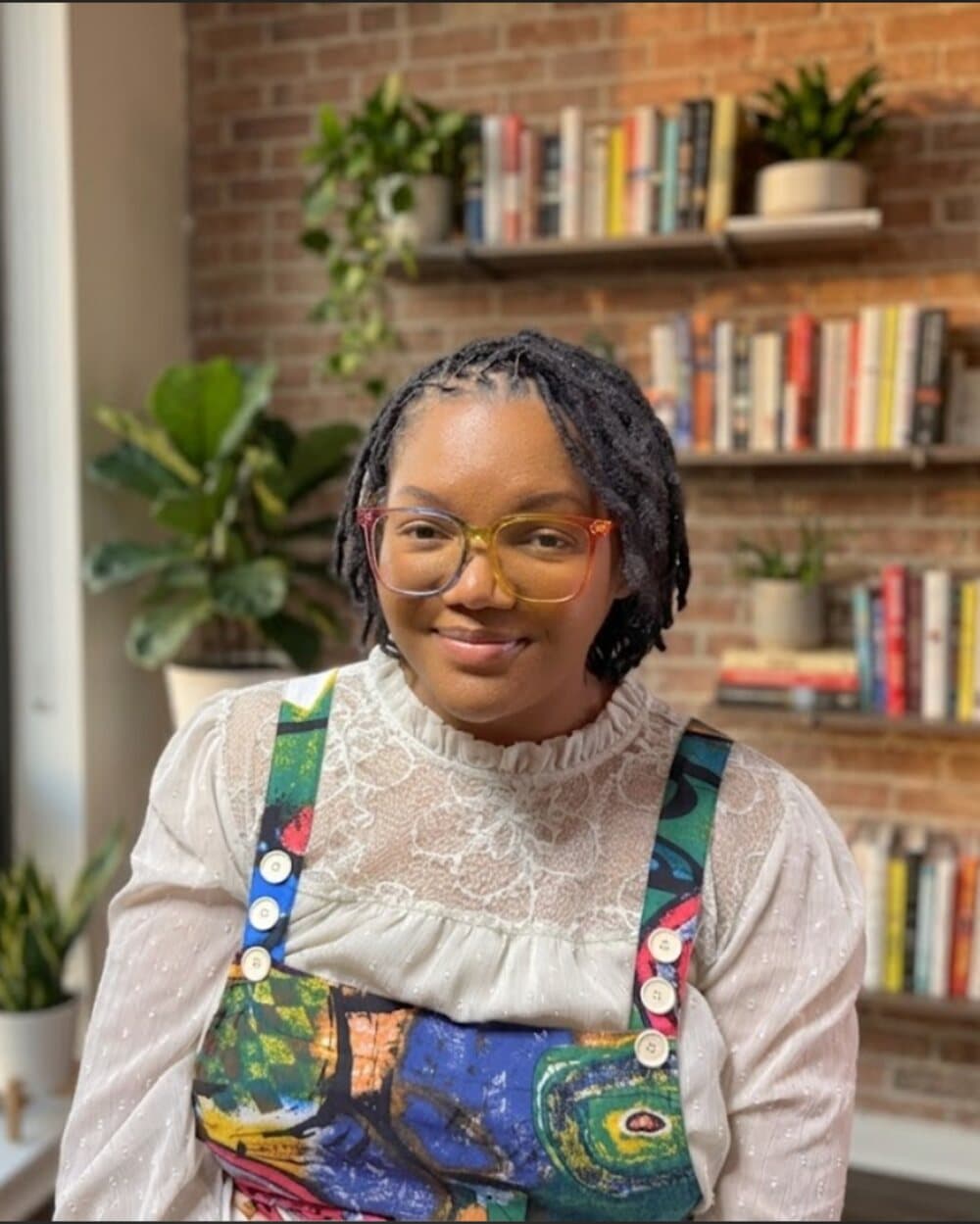 Makeda Boehm in front of a bookshelf